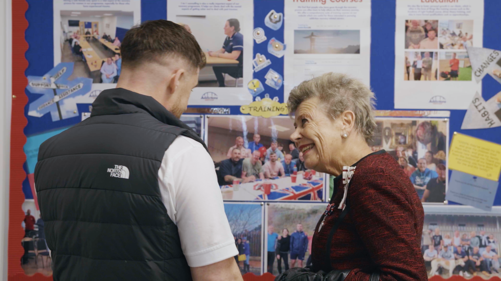 Sue Snowdon speaking with Michael about one of the notice boards